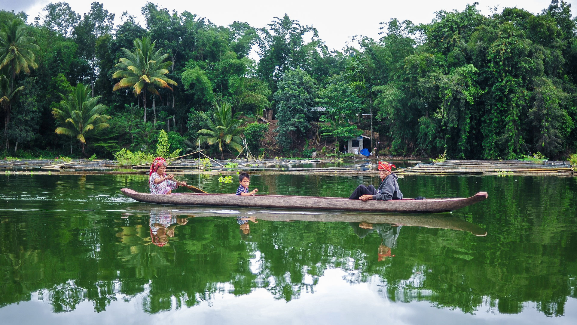 A T’boli family paddles peacefully across Lake Sebu, Philippines, on an early morning (Photo: Maria Louella Tinio)